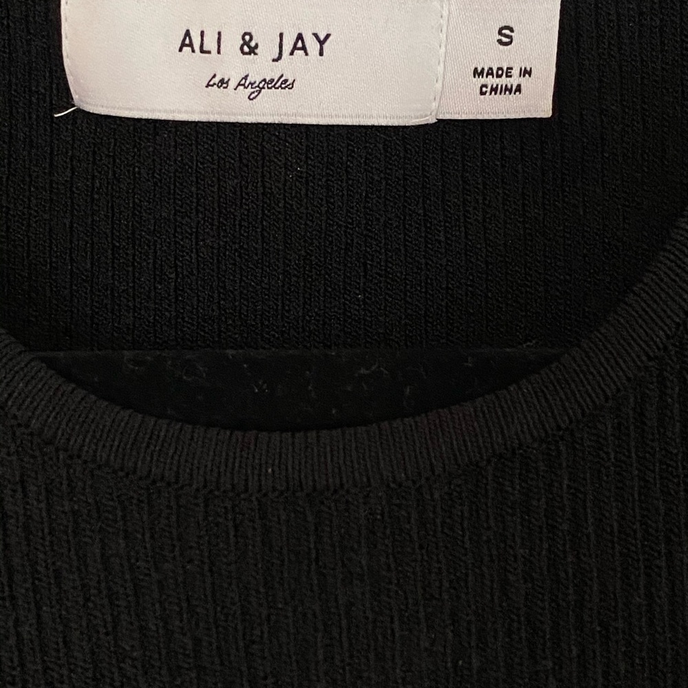 Ladies black knit dress, slight ruffle on sleeve.